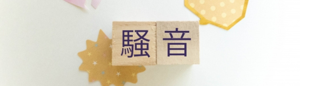 木製ブロックに書かれた「騒音」の文字と装飾された背景。