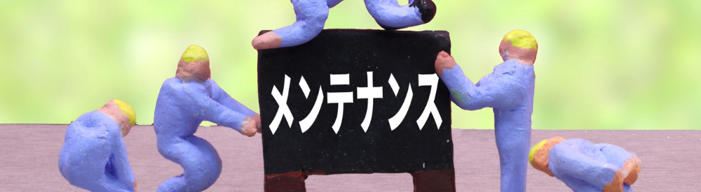 ミニチュアの作業員たちが「メンテナンス」と書かれた黒板を運んでいる画像