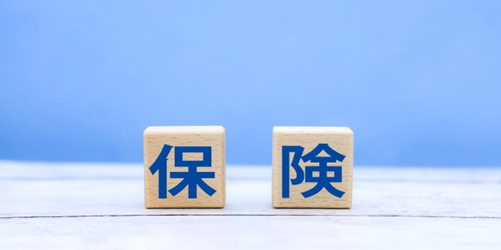 青背景と木製ブロックに「保険」と書かれた文字が並ぶシンプルな構成のイメージ画像